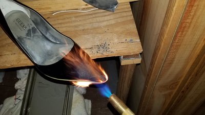 Stinky shoe roasting on an open fire